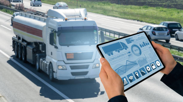 Manager with a digital tablet on the background of truck. Fleet management Manager with a digital tablet on the background of truck. Fleet management