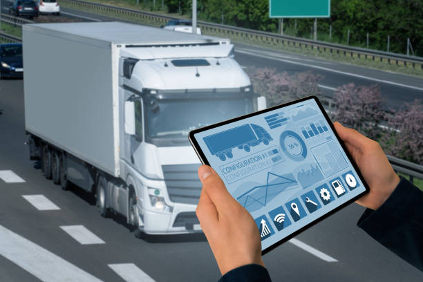 Manager with a digital tablet on the background of truck. Fleet management Manager with a digital tablet on the background of truck. Fleet management