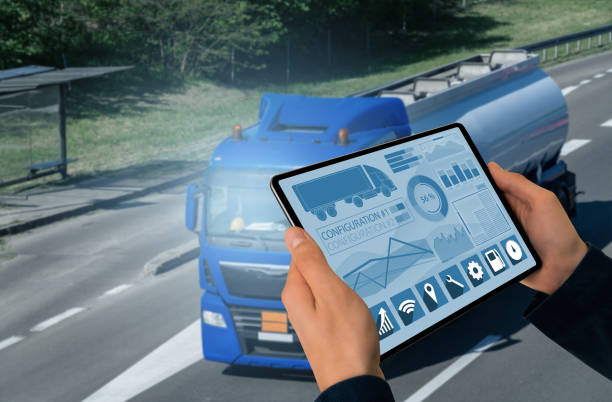 Manager with a digital tablet on the background of truck. Fleet management Manager with a digital tablet on the background of truck. Fleet management