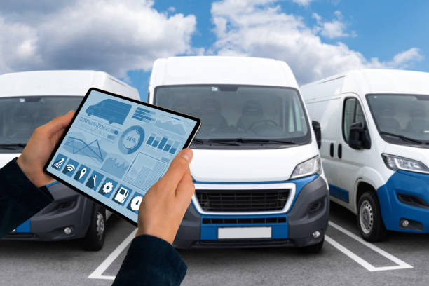 Manager with a digital tablet on the background of vans. Fleet management Manager with a digital tablet on the background of vans. Fleet management