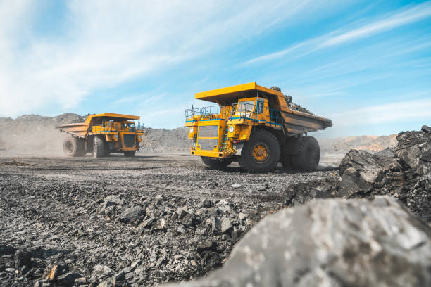 Large quarry dump truck. Loading the rock in the dumper. Loading coal into body work truck. Mining truck mining machinery, to transport coal from open-pit as the Coal. Production useful minerals