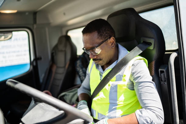 Trucker driver inside the truck at a construction site Trucker driver inside the truck at a construction site