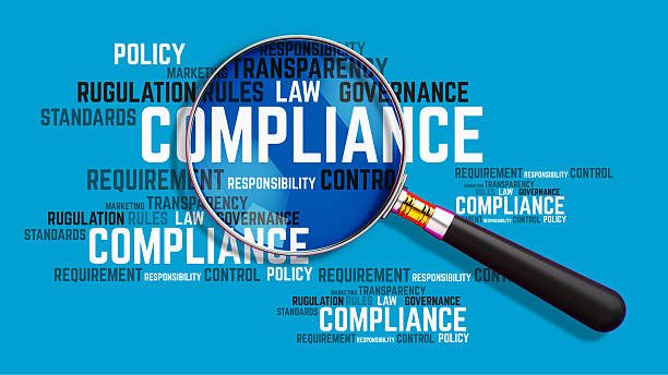 A magnifying glass focuses on the word "COMPLIANCE" within a dynamic word cloud of related business terms like policy, regulation, law, governance, and responsibility. This 3D illustration, set against a clean blue background, symbolizes the critical analysis and scrutiny required in corporate governance and risk management. It's a perfect visual for presentations and articles on business ethics, legal standards, auditing processes, and the importance of a transparent and well-controlled corporate framework.